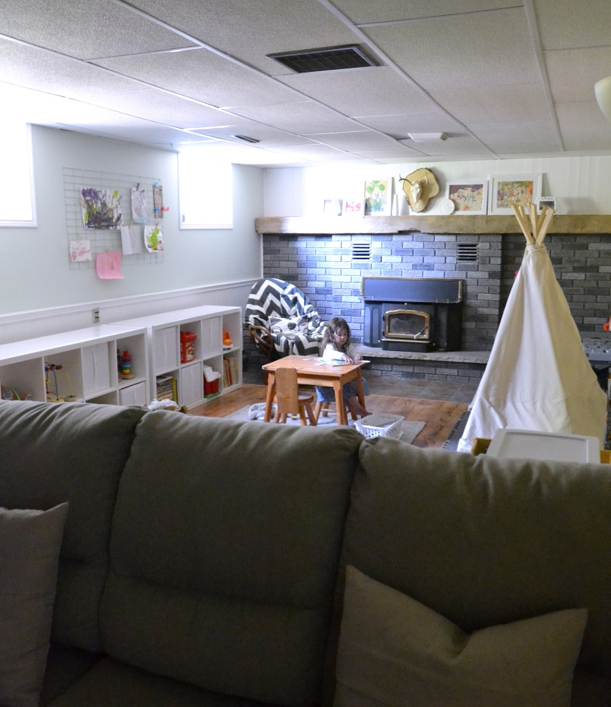 Fireplace makeover DIY with a grey paint wash on red brick.