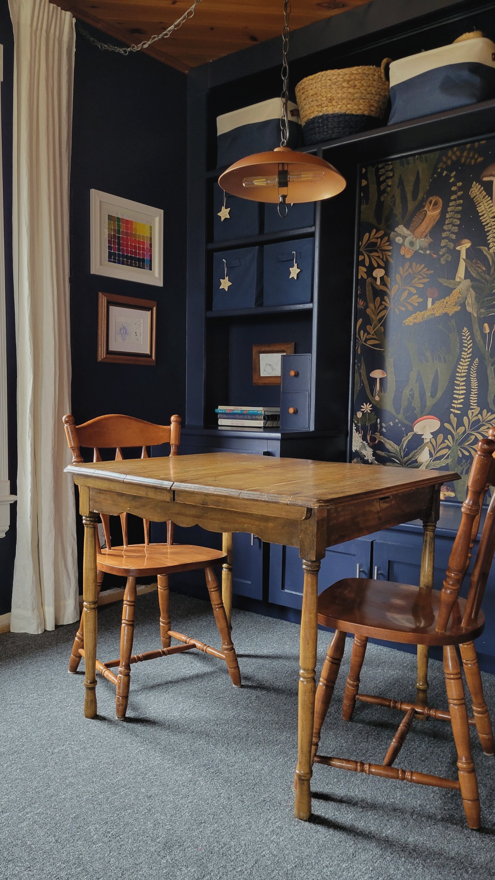 A navy blue build-in cabinet becomes a kids art station.