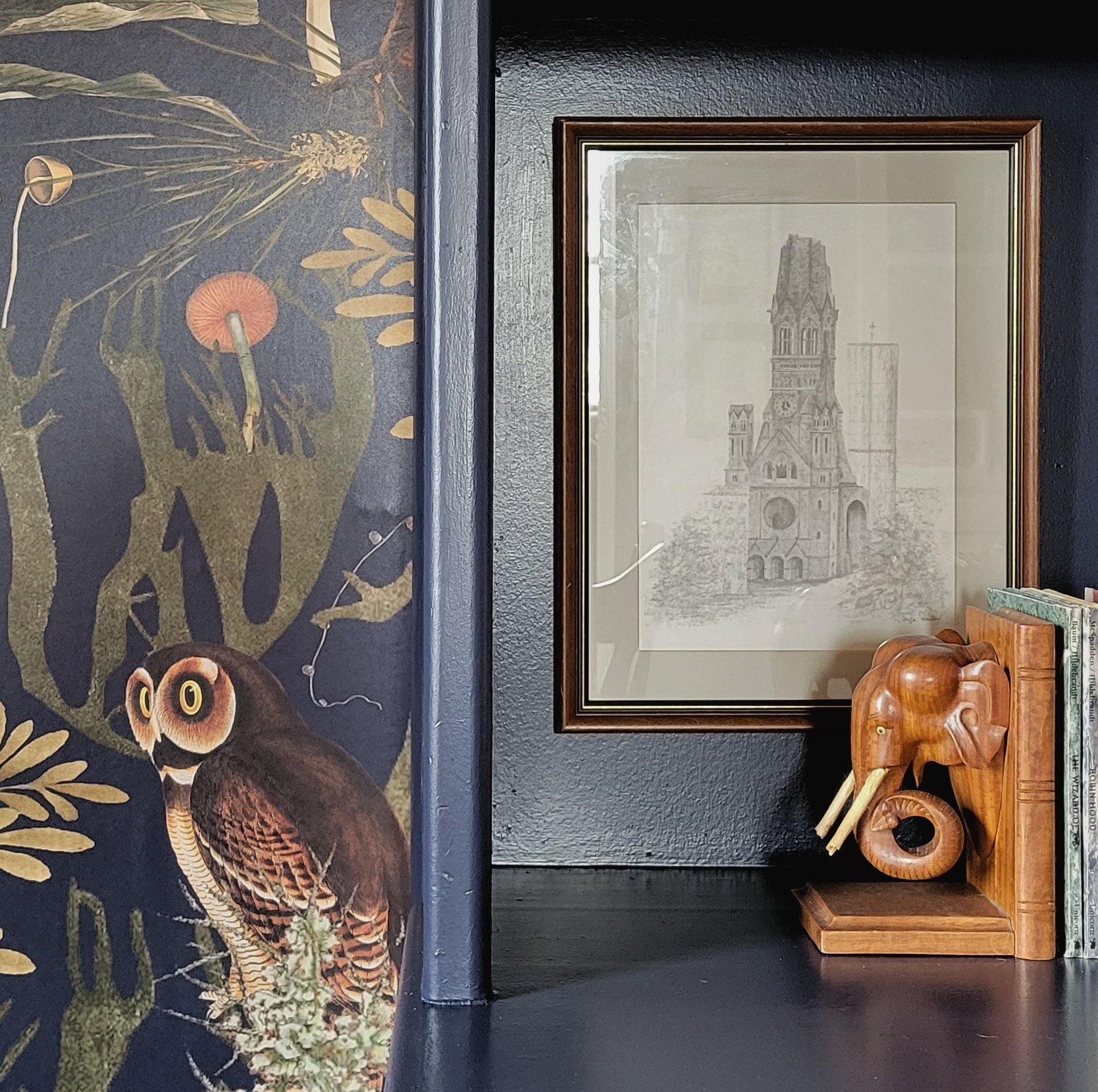 Thrifted elements, like art books, framed sketches and wood bookends add playful texture.