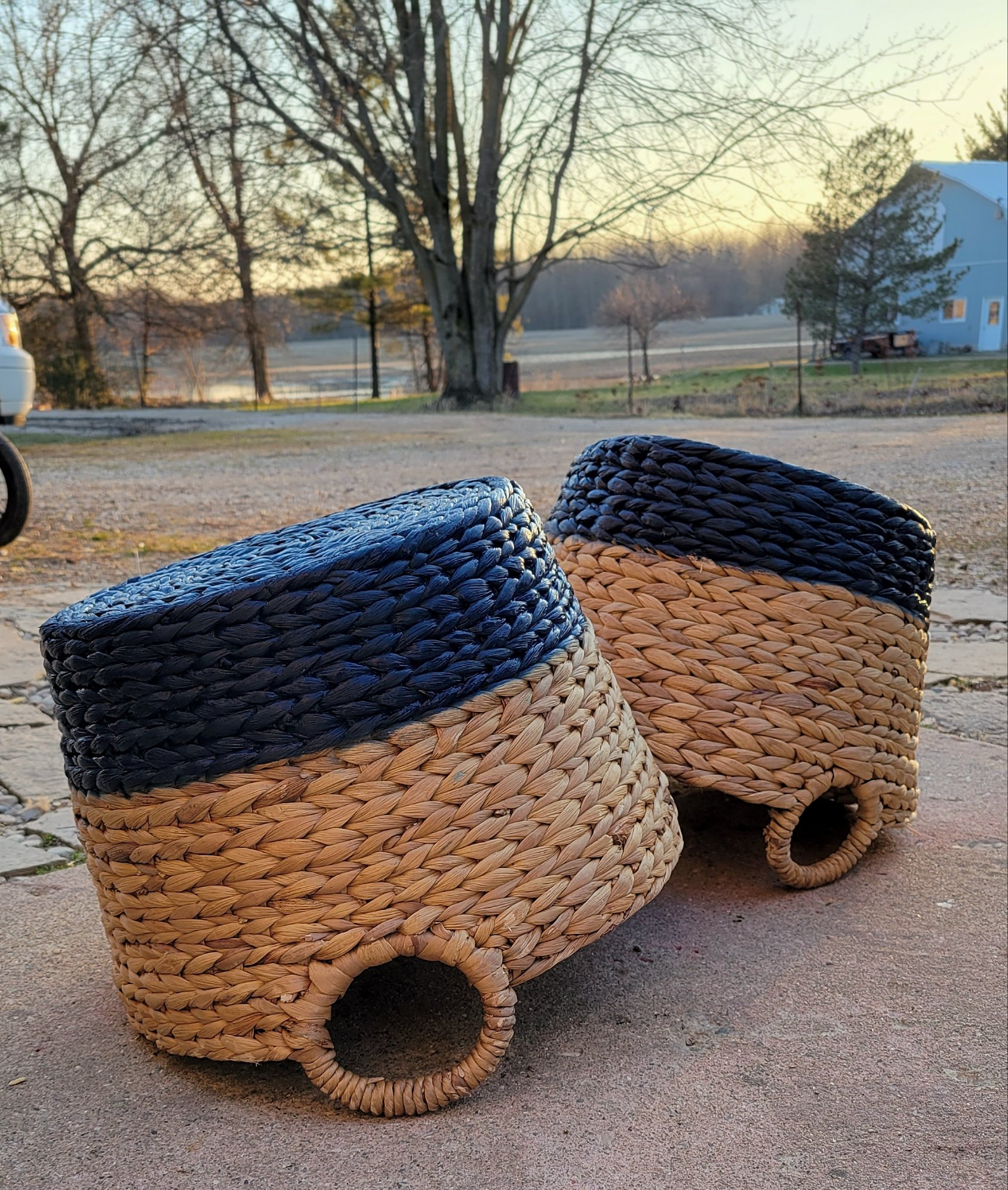 Wicker baskets painted with a blue stripe.